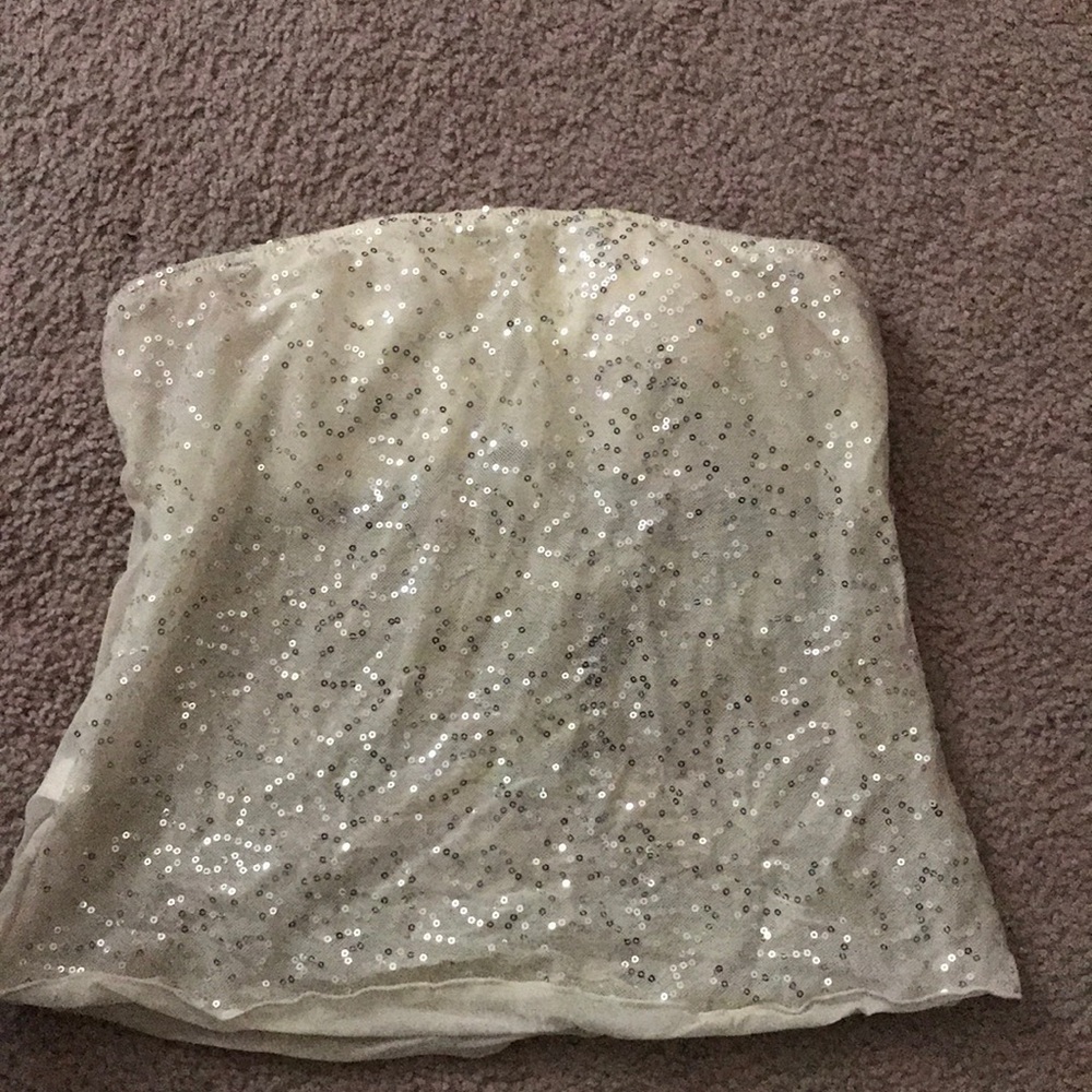 A strapless white glittery shirt